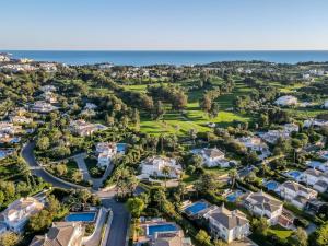 an aerial view of a neighborhood with houses and the ocean at Alcore Luxury Golf Villa at Alto Golf Alvor in Alvor