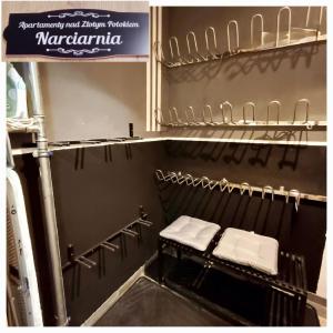 a bathroom with three folded towels on a shelf at Apartamenty nad Złotym Potokiem in Szklarska Poręba