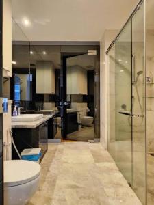 a bathroom with a shower and a toilet and a sink at The Platinum KLCC By Victoria Home in Kuala Lumpur