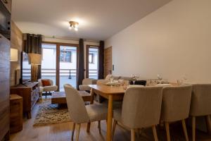 a dining room with a table and chairs at Charming three-room apartment in Huez - Welkeys in LʼHuez
