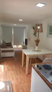 a living room with a table and a couch at CABAÑA MOAI in Mar del Plata
