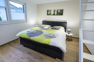 a bedroom with a large bed with towels on it at Chalet Terraluna in Heimbach