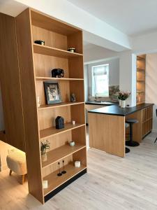 an office with a desk in a room with wooden shelves at Balcescu Downtown Apartment in Bistriţa