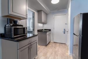 a kitchen with a microwave and a refrigerator at Oceanfront Views, Private Porch, 1st Flr, King Bed in Pawleys Island