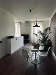 a living room with a table and chairs in it at LOFT MANZONI 37 in Cremona