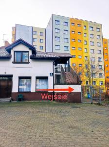 a building with a usgate sign on the side of it at Kora in Sosnowiec