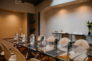 a meeting room with a long table and chairs at Loly Boutique Hotel Roma in Rome