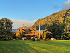 a large building in the middle of a grass field at Dalen Hotel in Dalen