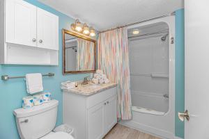 a bathroom with a toilet and a sink and a shower at Immaculate! Beautifully Renovated Oceanfront 1 Bedroom Suite - Sleeps 6! - Roxanne Towers Unit 804 in Myrtle Beach +29 photos