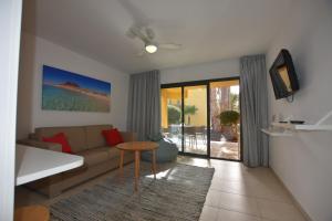 a living room with a couch and a table at Book Jet - Atlantic Dream Apartment & wifi in Corralejo