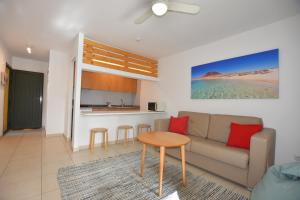 a living room with a couch and a table at Book Jet - Atlantic Dream Apartment & wifi in Corralejo