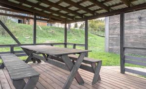 a picnic table and a bench on a deck at Pirtis link Moletu in Vilnius