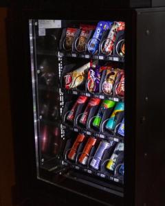 a vending machine filled with lots of soda drinks at Hotel Gloria KS in Prishtinë