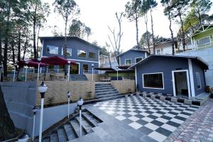 a house with a checkered floor in front of it at The Nature Trinket Regency in Dalhousie