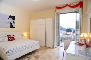 a bedroom with a bed and a sliding glass door at Elizabeth House in Como