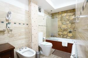 uma casa de banho com um WC, uma banheira e um lavatório. em Cabañas Tierra Mistica em Ushuaia