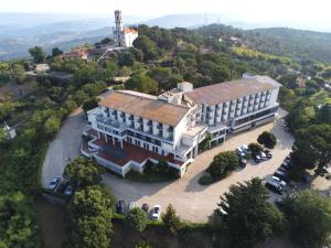 an overhead view of a large building with cars parked in front at Hotel Senhora do Castelo in Mangualde