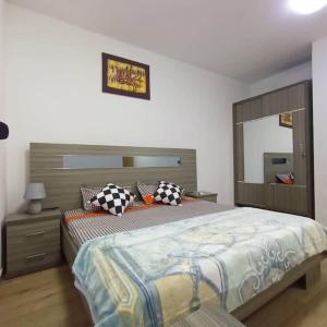 a bedroom with a large bed with pillows on it at Appartement F4 meublé à Dakar in Dakar