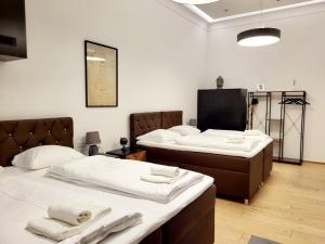 a room with two beds with towels on them at City Apartment Schotten Vienna in Vienna