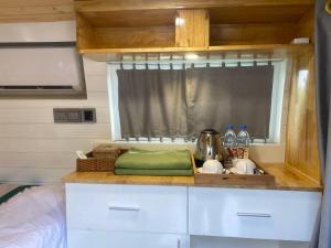 a kitchen counter with a sink and a window at Kep Orchid Boutique Resort in Kep