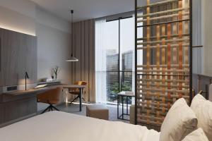 a hotel room with a bed and a desk and a window at Residence Inn by Marriott Santiago de los Caballeros in Santiago de los Caballeros