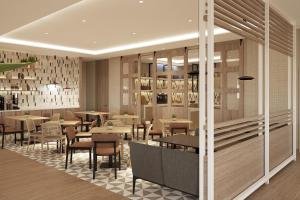 a restaurant with tables and chairs in a room at Residence Inn by Marriott Santiago de los Caballeros in Santiago de los Caballeros