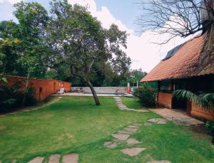 a yard with a tree and a building at Recanto Rocas in Pirenópolis