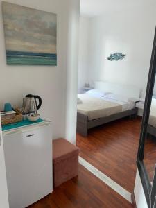 a bedroom with a bed and a table in a room at Sollevante Guest House in Riomaggiore