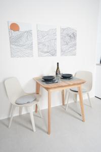 a table with two chairs and a bottle of wine at Kur-Apartment Matilda in Waldbronn