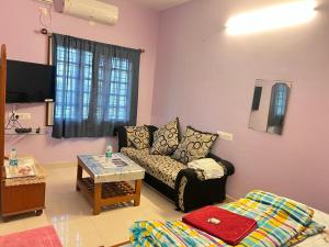 班加羅爾的住宿－HSR Homestay Chethana，客厅配有沙发和桌子