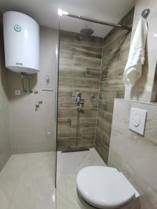 a bathroom with a toilet and a glass shower at Brvnara Vidra in Pale