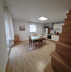 a kitchen and dining room with a table and chairs at Ferienhaus Alexandra in Böllenborn