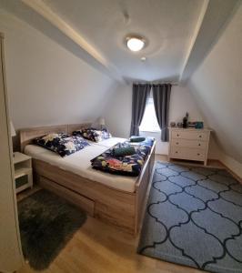 a bedroom with a large bed and a window at Ferienhaus Alexandra in Böllenborn