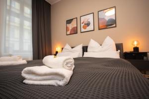 una camera d'albergo con asciugamani su un letto di City-Appartment im Bachhviertel a Lipsia