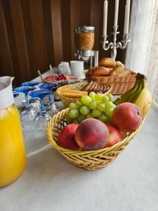 a table with two baskets of fruit and bread at Sport & Freizeit Centrum Pension in Heudeber