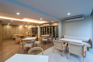 a dining room with tables and chairs and tablesktop at Aonang All Seasons Beach Resort in Ao Nang Beach