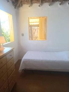 een slaapkamer met een bed en een raam bij Casa del Artista, Ilha Grande Araçatiba in Angra dos Reis