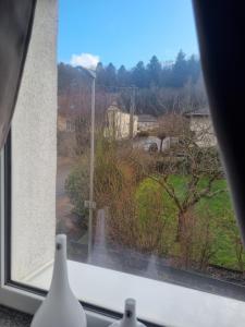 a window with a view of a garden at Ferienhaus Alexandra in Böllenborn