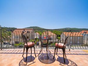 a patio with two chairs and a table on a balcony at Villa Pero & Jele in Mlini