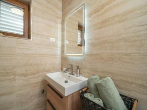 a bathroom with a sink and a mirror at Villa Pero & Jele in Mlini +27 photos
