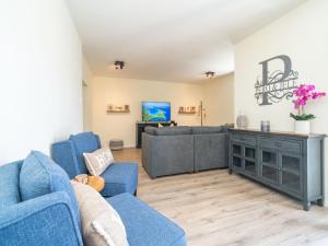 a living room with blue chairs and a couch at Villa Pero & Jele in Mlini