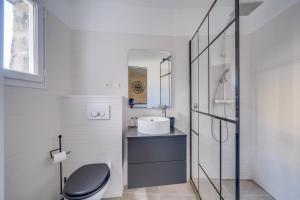 a bathroom with a toilet and a sink at Charming apartment in the heart of Bordeaux in Bordeaux
