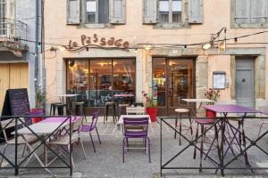 a group of tables and chairs in front of a store at Le Passage in Carcassonne
