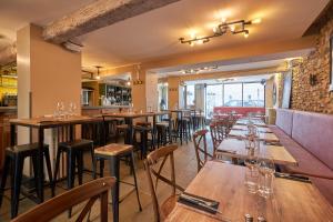 a row of tables and chairs in a restaurant at Le Passage in Carcassonne