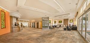 a lobby of a hotel with people sitting at tables at Huinid Pioneros Hotel in San Carlos de Bariloche