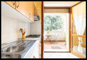 a kitchen with a sink and a stove top oven at Palazzo Wanny Free Parking & Terrace in Florence