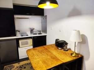 a kitchen with a wooden table with a lamp on it at Charming apartment downtown Bordeaux in Bordeaux