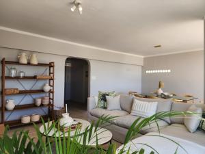 a living room with a couch and a table at Sandy Lodge 201 in Cape Town