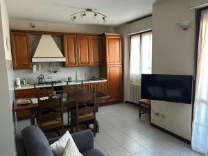 a kitchen with a table and a dining room at Appartamento con vista in Brescia