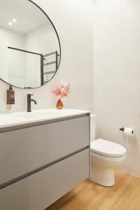 a bathroom with a toilet and a mirror at Eki Terrace by FeelFree Rentals in Donostia-San Sebastián +32 photos